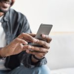Young man using smart phone at home